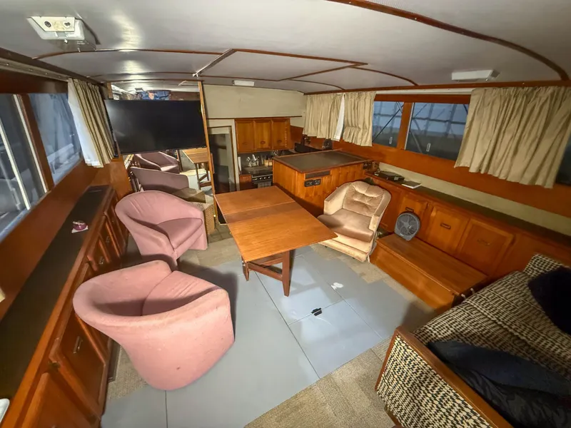 Slide: The Image of Interior of a 1977 Pacemaker FB Motor Yacht with cozy seating and wooden furnishings. - 24
