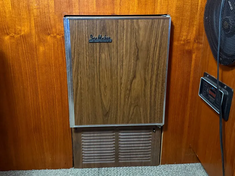 Slide: The Image of A wooden refrigerator in a yacht with a SeaMaster logo. - 27