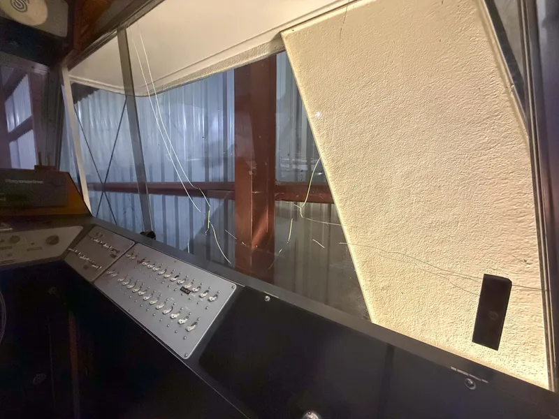 Slide: The Image of Interior view of a 1977 Pacemaker FB Motor Yacht with a damaged window. - 15