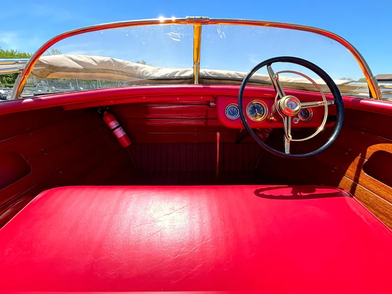Slide: The Image of The image shows the cockpit of a 1956 Chris-Craft Capri with red leather and wood details. - 18
