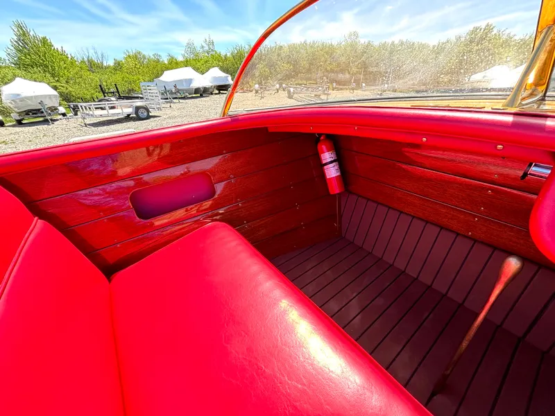 Slide: The Image of Interior of a 1956 Chris-Craft Capri with red leather seats and wood paneling. - 19