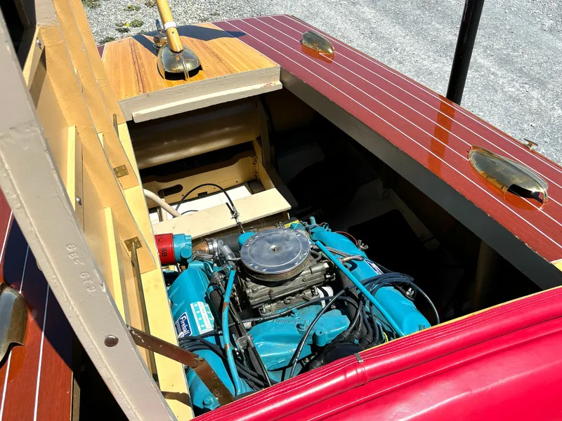Slide: The Image of A 1956 Chris-Craft Capri with an open engine compartment revealing a blue engine. - 26