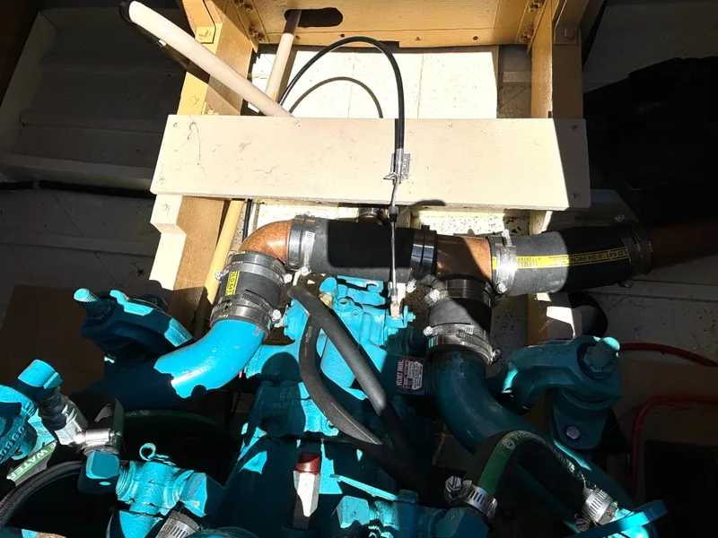 Slide: The Image of Engine compartment of a 1956 Chris-Craft Capri with blue pipes and hoses. - 28