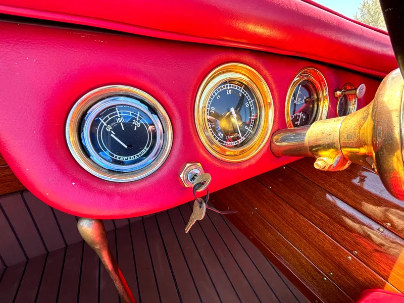 Slide: The Image of The image shows the dashboard of a 1956 Chris-Craft Capri with red upholstery and classic gauges. - 22