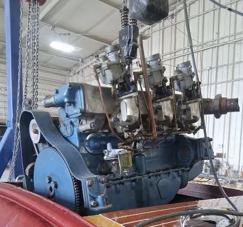 Slide: The Image of An engine in a workshop, likely from a 1956 Chris-Craft Capri boat. - 31