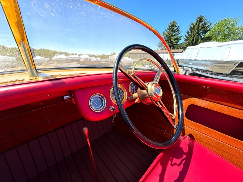 Slide: The Image of The image shows the cockpit of a 1956 Chris-Craft Capri with red interior and wood paneling. - 20