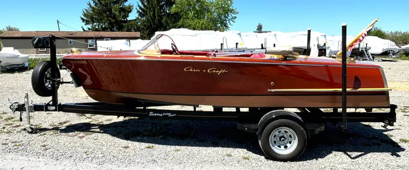 Slide: The Image of 1956 Chris-Craft Capri on a trailer, featuring a glossy wood finish and classic design. - 6