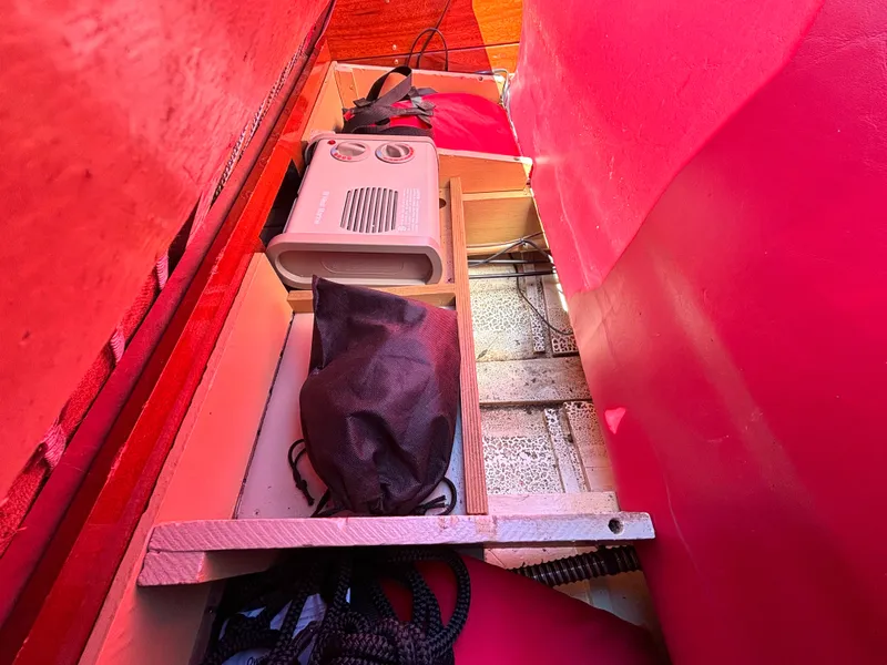 Slide: The Image of Interior of a 1956 Chris-Craft Capri with red upholstery and storage space. - 25