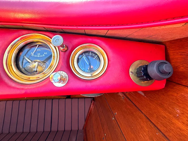 Slide: The Image of Close-up of a 1956 Chris-Craft Capri dashboard with red upholstery and wood accents. - 23