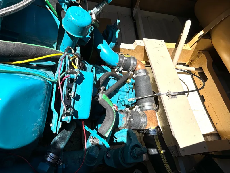 Slide: The Image of The engine compartment of a 1956 Chris-Craft Capri with blue engine components and hoses. - 29