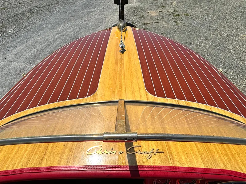 Slide: The Image of A classic 1956 Chris-Craft Capri boat with polished wood deck and elegant design. - 9