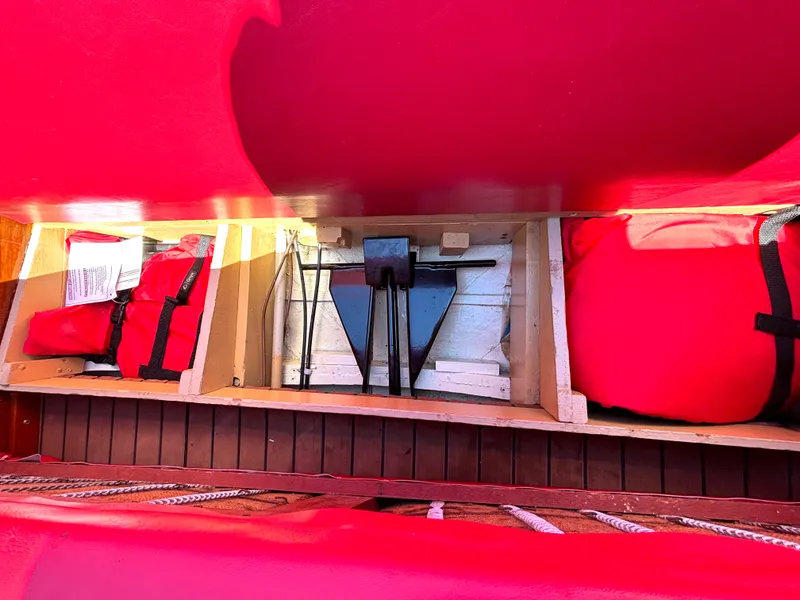 Slide: The Image of A view inside the storage of a 1956 Chris-Craft Capri with red life jackets. - 16