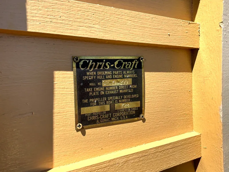 Slide: The Image of Chris-Craft plaque on a boat hull, displaying model and engine details. - 39