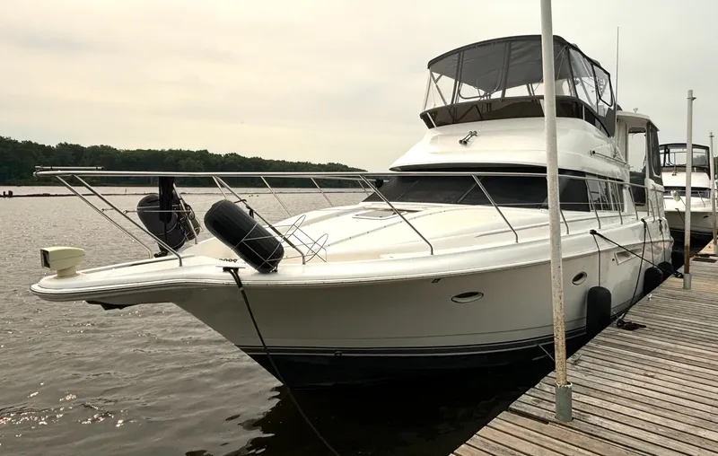The Image of A 2000 Silverton 422 Motor Yacht docked at a wooden pier. - 1