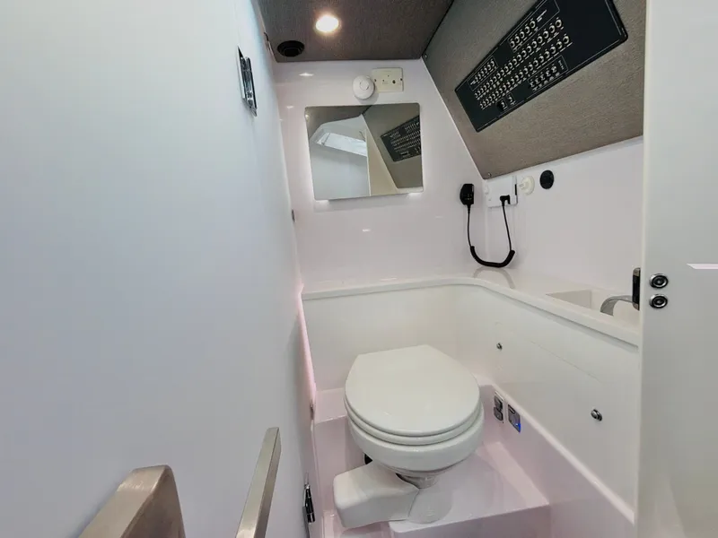 Slide: The Image of The image shows a modern bathroom in a 2020 Axopar 37 XC Cross Cabin. - 39