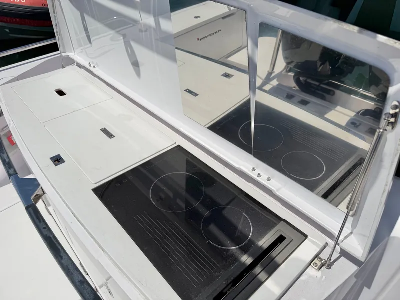 Slide: The Image of The 2020 Axopar 37 XC Cross Cabin features a modern outdoor kitchen with two cooktops. - 16