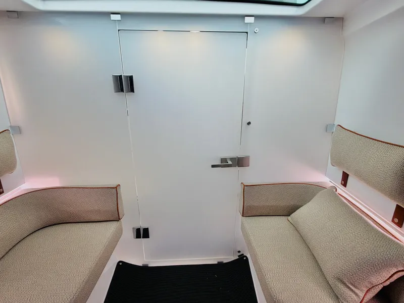 Slide: The Image of Interior of the 2020 Axopar 37 XC Cross Cabin with two cushioned seats and a door. - 35