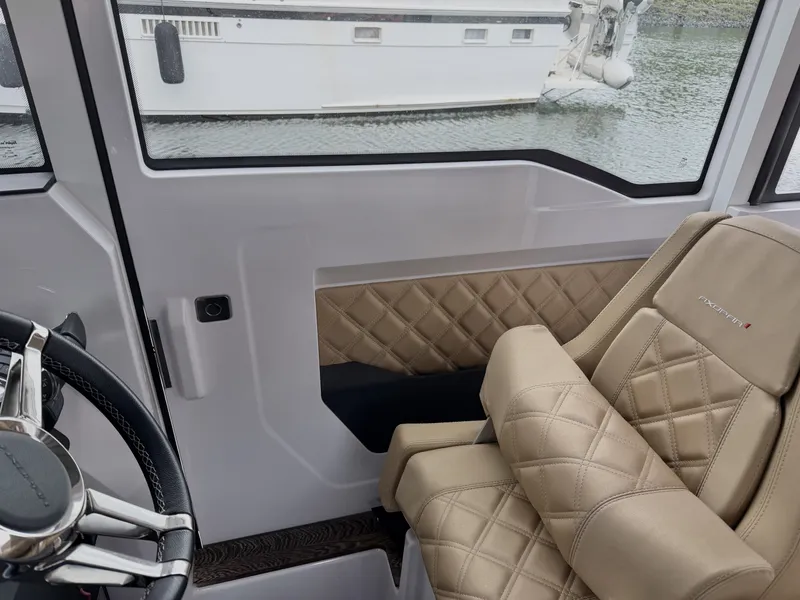Slide: The Image of Interior of a 2020 Axopar 37 XC Cross Cabin with beige quilted seating. - 30