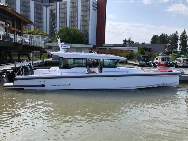 The Image of A 2020 Axopar 37 XC Cross Cabin boat docked in a harbor. - 1
