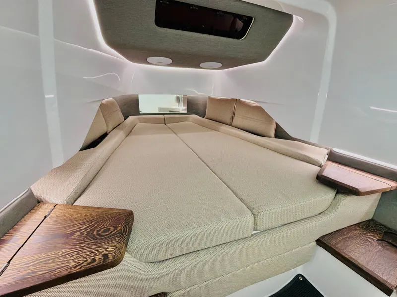 Slide: The Image of Interior of the 2020 Axopar 37 XC Cross Cabin with beige upholstery and wood accents. - 36