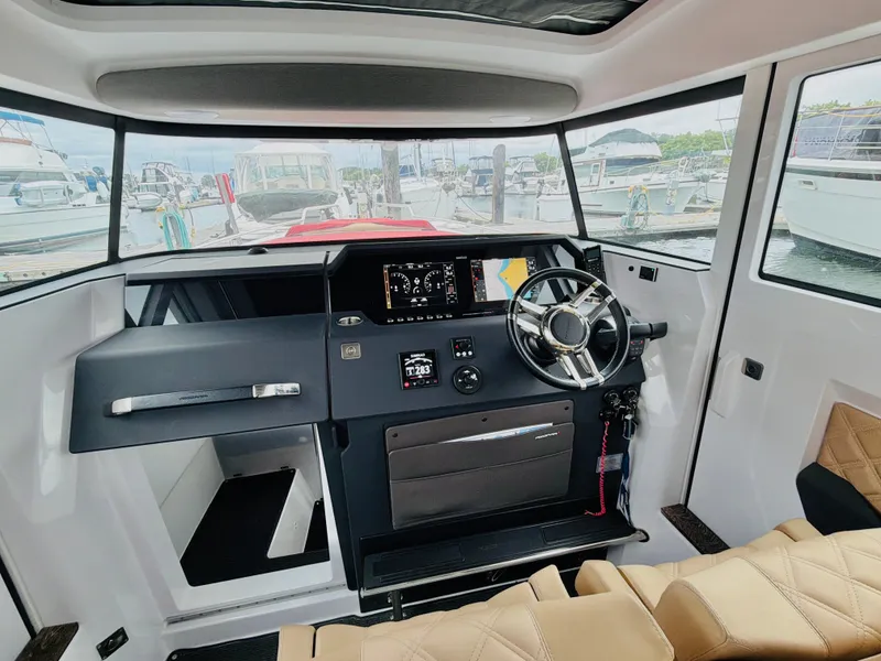 Slide: The Image of Interior of the 2020 Axopar 37 XC Cross Cabin with modern helm and beige seating. - 34