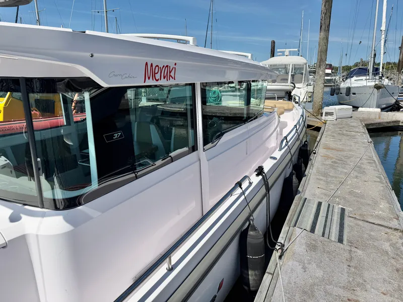 Slide: The Image of 2020 Axopar 37 XC Cross Cabin docked, featuring a sleek design. - 22