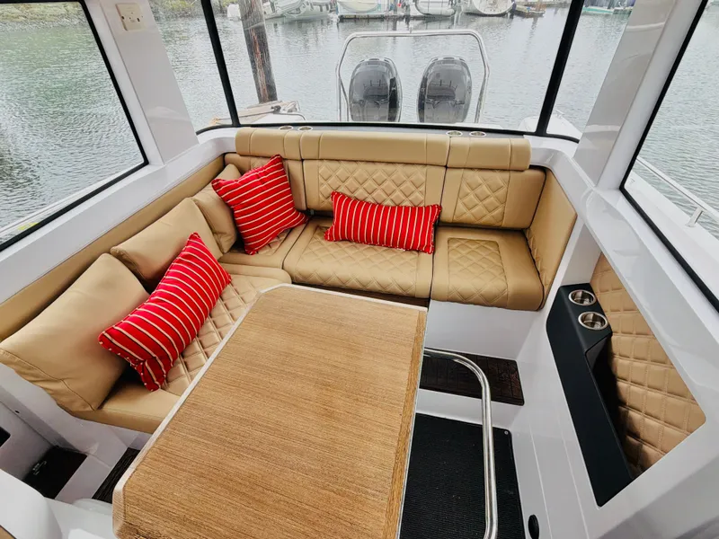 Slide: The Image of Interior of an Axopar 37 XC Cross Cabin with beige seating and red cushions. - 26