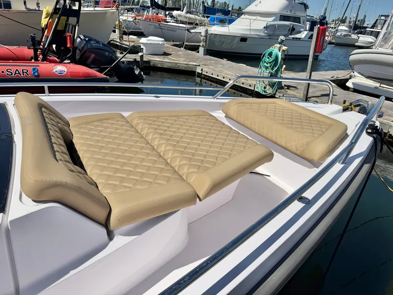 Slide: The Image of The image shows the foredeck of a 2020 Axopar 37 XC Cross Cabin with beige cushions. - 21