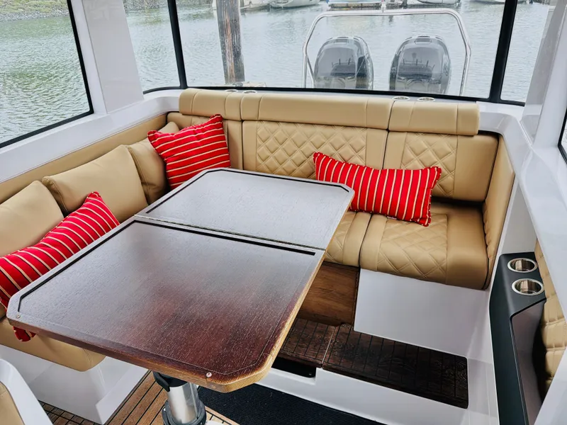 Slide: The Image of Interior of the Axopar 37 XC Cross Cabin with beige seating and red cushions. - 28