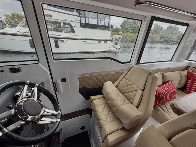 Slide: The Image of Interior of a 2020 Axopar 37 XC Cross Cabin with beige seats and red cushions. - 29