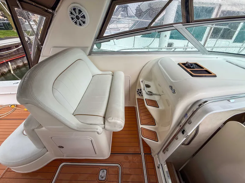 Slide: The Image of Interior of a 1997 Sea Ray 330 Express Cruiser with white seating and wooden flooring. - 15