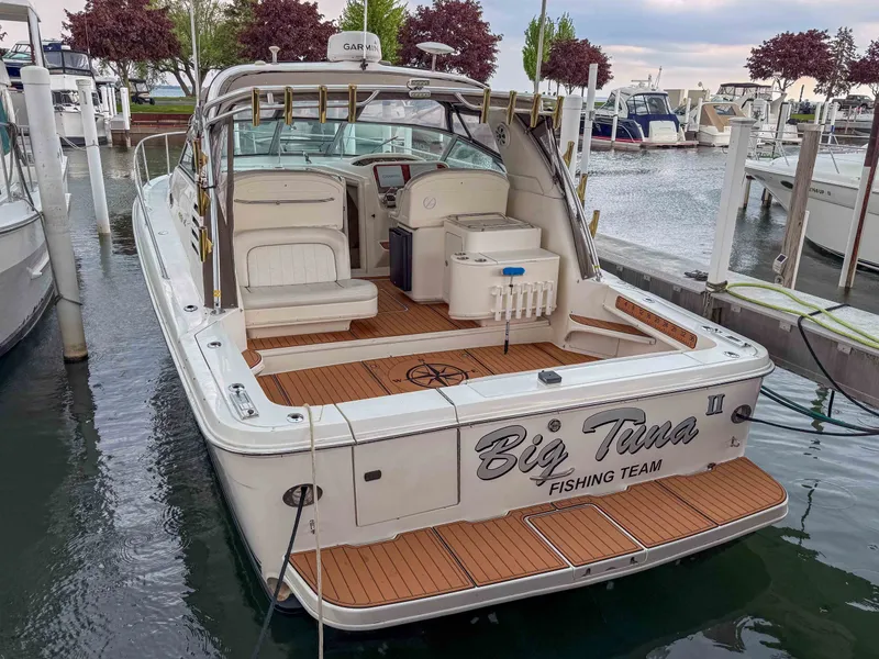 The Image of 1997 Sea Ray 330 Express Cruiser docked, featuring wood deck and "Big Tuna" lettering. - 1