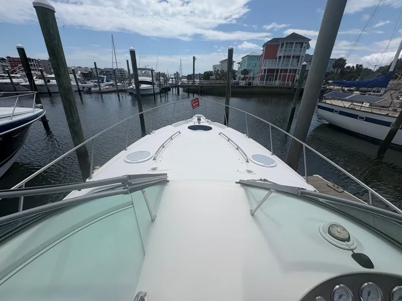 Slide: The Image of The boat is docked in a marina, surrounded by other boats and waterfront buildings. - 13