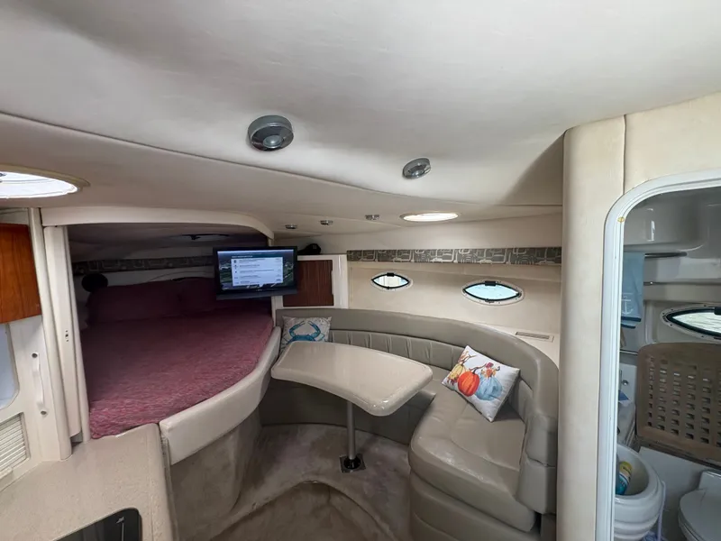 Slide: The Image of The 2000 Monterey 322 Cruiser cabin features a cozy bed, TV, and seating area. - 29