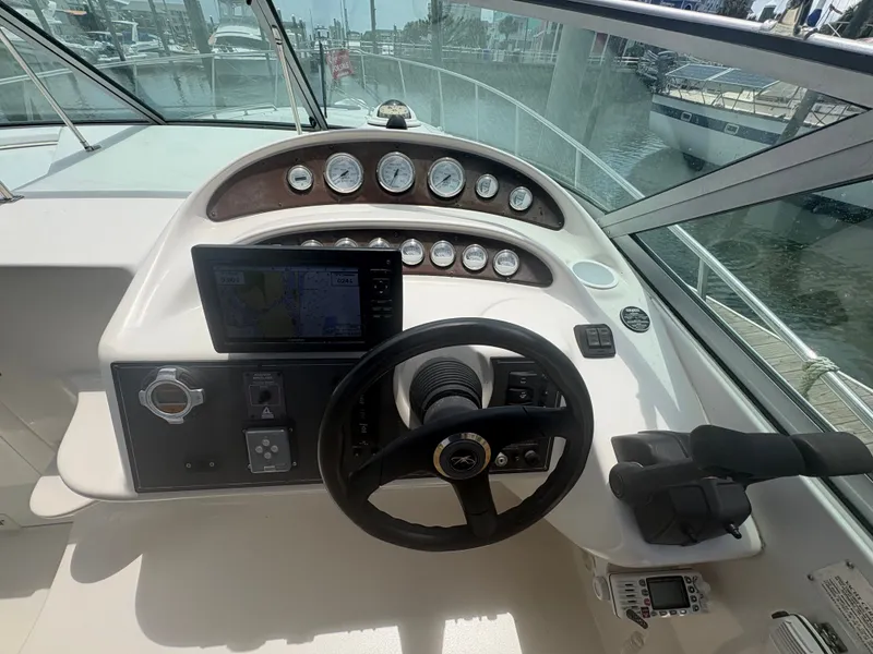 Slide: The Image of The cockpit of a 2000 Monterey 322 Cruiser with steering wheel, gauges, and navigation system. - 16