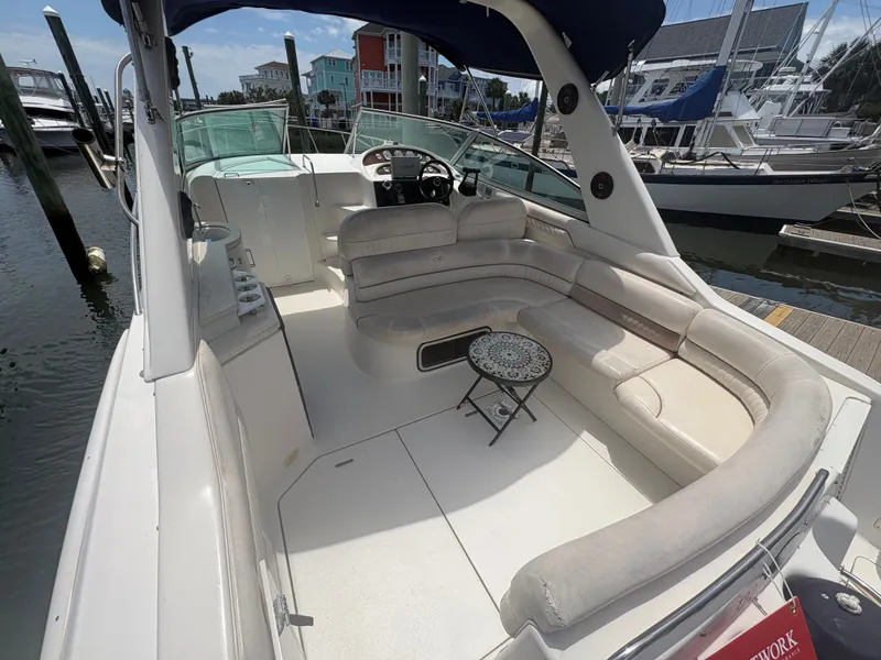 Slide: The Image of The image shows the cockpit of a 2000 Monterey 322 Cruiser with beige seating and a small table. - 7