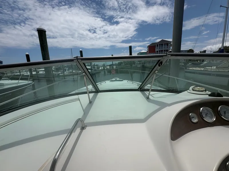 Slide: The Image of The image shows the cockpit of a 2000 Monterey 322 Cruiser at a marina. - 14