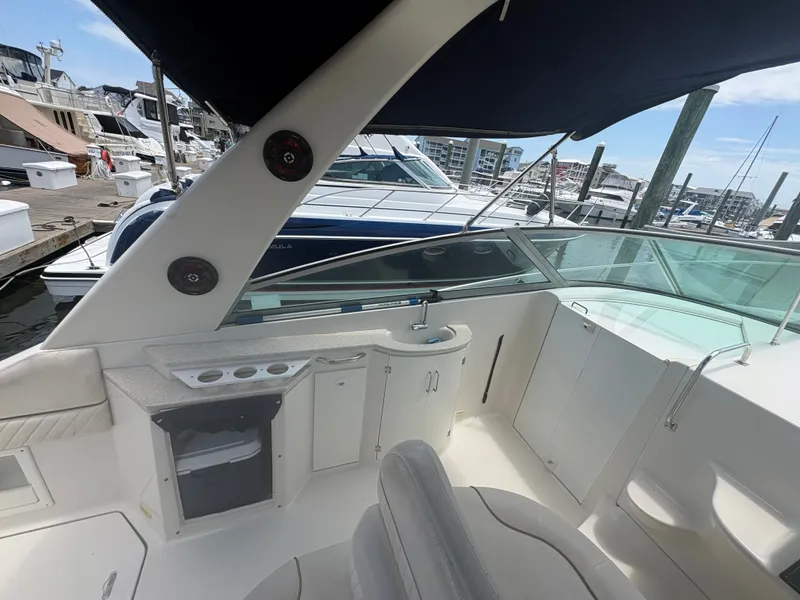 Slide: The Image of The image shows the cockpit of a 2000 Monterey 322 Cruiser with seating and a helm console. - 9