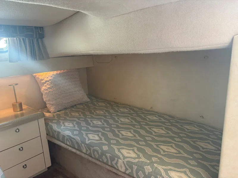 Slide: The Image of Interior of the 2000 Monterey 322 Cruiser with a single bed and drawers. - 39