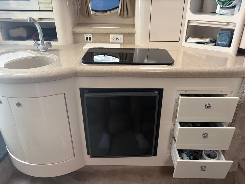 Slide: The Image of Galley area with sink, stove, and drawers in a 2000 Monterey 322 Cruiser. - 35