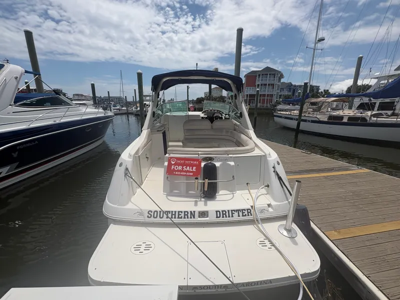 Slide: The Image of 2000 Monterey 322 Cruiser docked, with a 'For Sale' sign at the stern. - 2