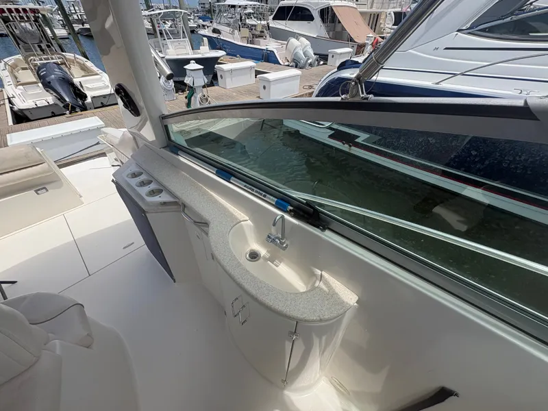 Slide: The Image of The image shows the cockpit of a 2000 Monterey 322 Cruiser with a small sink. - 10