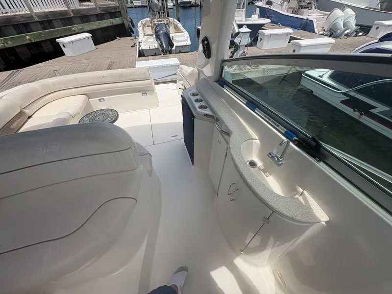Slide: The Image of The image shows the cockpit of a 2000 Monterey 322 Cruiser with beige seating and a small sink. - 11