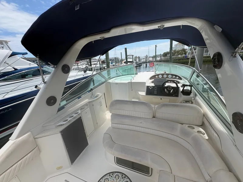 Slide: The Image of The image shows the cockpit of a 2000 Monterey 322 Cruiser with white seating and a helm station. - 8