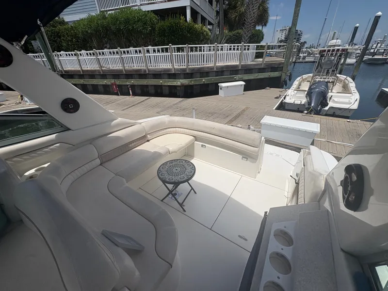 Slide: The Image of The image shows the cockpit of a 2000 Monterey 322 Cruiser with beige seating and a small table. - 12
