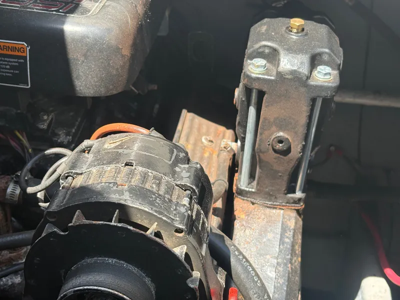 Slide: The Image of Close-up of an engine compartment with visible parts and wiring. - 46