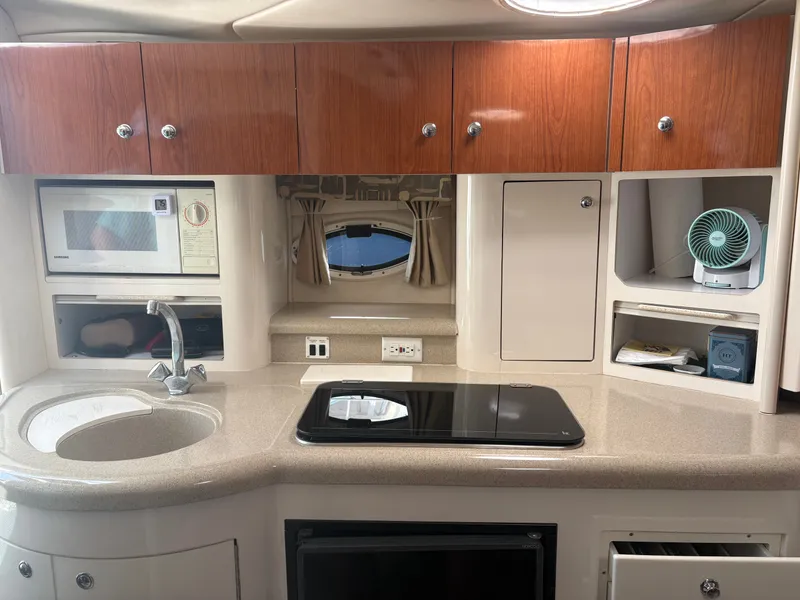 Slide: The Image of The galley of a 2000 Monterey 322 Cruiser with a sink, stove, and microwave. - 34