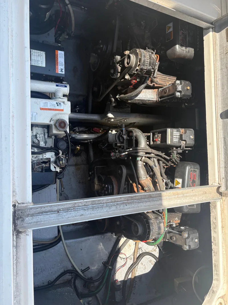 Slide: The Image of The engine compartment of a 2000 Monterey 322 Cruiser shows two engines and various mechanical components. - 47