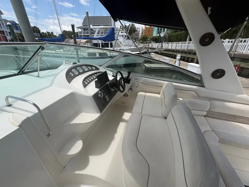Slide: The Image of The image shows the cockpit of a 2000 Monterey 322 Cruiser with white seats and dashboard. - 19