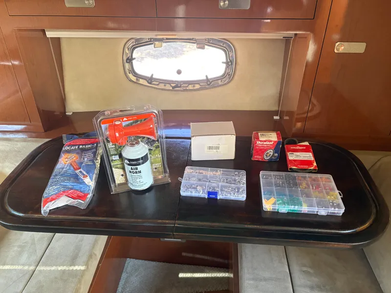 Slide: The Image of Interior of a Sea Ray Sundancer 310 with a table displaying various boating accessories. - 44
